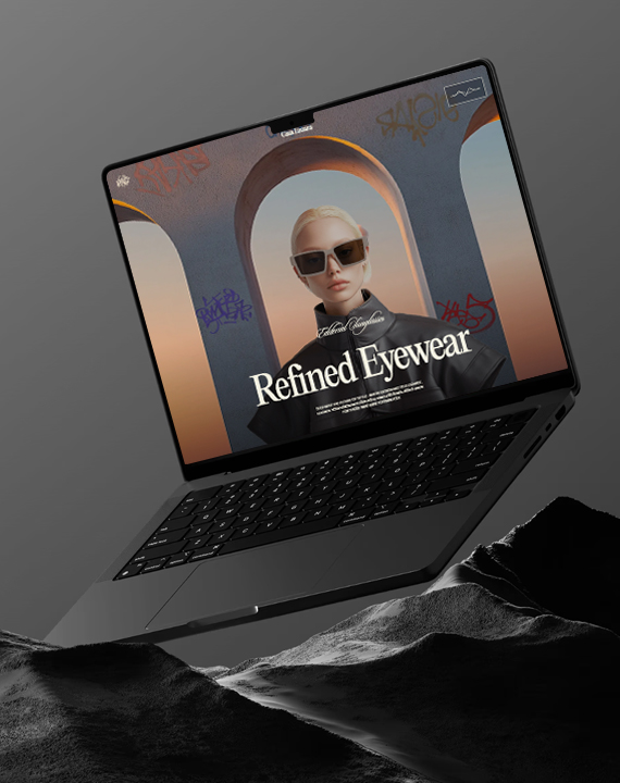 Dark laptop displaying eyewear website on rocks
